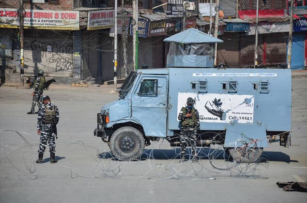 May 18, 2021, Srinagar, Jammu & Kashmir, India: Paramilitary troopers stand alert during a Coronavirus curfew imposed following the surge in COVID-19 cases in Srinagar. With the increasing number of COVID-19 cases in Jammu and Kashmir, the government has decided to extend the Coronavirus Curfew till May 25. .Jammu and Kashmir reported highest ever single day spike in the number of COVID-19 deaths as 73 persons succumbed to the virus. Also, 3,344 new COVID-19 cases have been reported, in last 24 hours. Meanwhile, India saw another grim record with 4,329 COVID-19 patients dying in the last 24 hours even as daily cases dropped to 263,000. Srinagar India - ZUMAs197 20210518_zaa_s197_009 Copyright: xSaqibxMajeedx