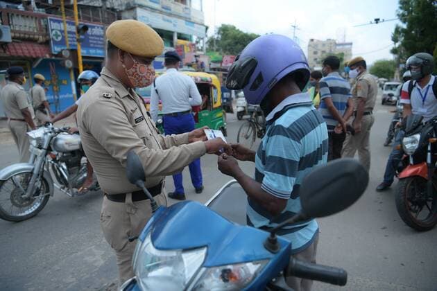 (210519) -- AGARTALA, May 19, 2021 -- Police personnel inspects motorcyclists along a road during a curfew in Agartala, the capital city of India s northeastern state of Tripura, May 19, 2021. India s COVID-19 tally reached 25,496,330 on Wednesday, with 267,334 new cases registered in the past 24 hours, confirmed the health ministry. In a bid to flatten the COVID-19 cases curve most of the states in the country have imposed night curfews and partial or complete lockdowns. (Str Xinhua) INDIA-AGARTALA-COVID-19-CURFEW Stringer