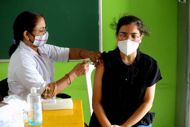 (210519) -- BHOPAL, May 19, 2021 -- A woman receives a shot of COVID-19 vaccine during the vaccination drive in Bhopal, the capital city of India s Madhya Pradesh state, May 19, 2021. India s COVID-19 tally reached 25,496,330 on Wednesday, with 267,334 new cases registered in the past 24 hours, confirmed the health ministry. So far over 185 million vaccination doses (185,809,302) have been administered to the people across the country since India kicked off a nationwide vaccination drive on Jan. 16. (Str Xinhua) INDIA-BHOPAL-COVID-19-VACCINATION Stringer