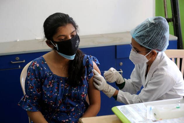 (210519) -- BHOPAL, May 19, 2021 -- A woman receives a shot of COVID-19 vaccine during the vaccination drive in Bhopal, the capital city of India s Madhya Pradesh state, May 19, 2021. India s COVID-19 tally reached 25,496,330 on Wednesday, with 267,334 new cases registered in the past 24 hours, confirmed the health ministry. So far over 185 million vaccination doses (185,809,302) have been administered to the people across the country since India kicked off a nationwide vaccination drive on Jan. 16. (Str Xinhua) INDIA-BHOPAL-COVID-19-VACCINATION Stringer