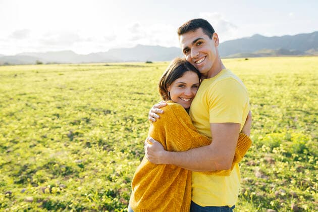 Smiling girlfriend embracing boyfriend on sunny day model released Symbolfoto MIMFF00694