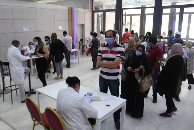 (210626) -- TUNIS, June 26, 2021 -- People line up to receive the COVID-19 vaccine at a vaccination site in Tunis, Tunisia, on June 26, 2021. Since the start of the nationwide vaccination campaign against coronavirus on March 13, a total of 1,705,657 people have received the vaccines, with 476,013 taking both doses, according to the latest figures published by Tunisian Health Ministry. (Photo by Xinhua) TUNISIA-TUNIS-COVID-19-VACCINATION AdelxEzzine