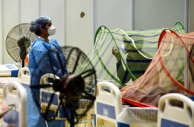 (210629) -- NEW DELHI, June 29, 2021 -- A doctor wearing personal protective equipment (PPE) checks a COVID-19 patient s oxygen level at a care center in New Delhi, India, June 29, 2021. India s COVID-19 tally rose to 30,316,897 on Tuesday as 37,566 new cases were registered during the past 24 hours. India reports less than 40,000 daily new cases after 102 days, said the federal health ministry in an official statement. (Photo by Xinhua) INDIA-NEW DELHI-COVID-19-CASES ParthaxSarkar