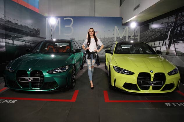 News Bilder des Tages June 30, 2021, Jakarta, Jakarta, Indonesia: Models pose between The All New BMW M3 and M4 Competition cars after a virtual launch in Jakarta, June 30, 2021. BMW Indonesia launched the two cars with three new colors, a high-performance 510hp 650Nm engine, and an expressive design as well as an eight-speed BMW M Steptronic transmission with Drivelogic and a series of innovative technologies developed by BMW M that will be offered for The new BMW M3 Competition with the price of IDR 2,059 billion off the road, while the New BMW M4 Competition Coupe will be offered at a price of IDR 2.119 billion off the road. Jakarta Indonesia - ZUMAr173 20210630_zip_r173_008 Copyright: xDasrilxRoszandix