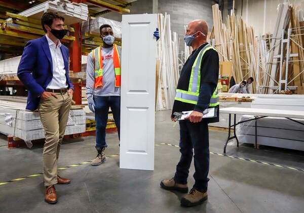 July 7, 2021, Calgary, ab, Canada: Prime Minister Justin Trudeau, left, tours the AAA Door company in Calgary, Alta., Wednesday, July 7, 2021. Calgary Canada - ZUMAc35_ 20210707_zaf_c35_006 Copyright: xJeffxMcintoshx