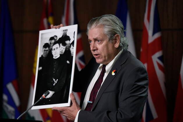 July 8, 2021, Ottawa, on, Canada: NDP MP Charlie Angus holds a photo of Fr. Arthur Lavoie, who died in 1991 and was named in over 300 reports of physical and sexual abuse, during a news conference calling on Minister of Justice David Lametti to investigate crimes against Indigenous people in Canada at residential schools, on Parliament Hill in Ottawa, on Thursday, July 8, 2021. Ottawa Canada - ZUMAc35_ 20210708_zaf_c35_010 Copyright: xJustinxTangx