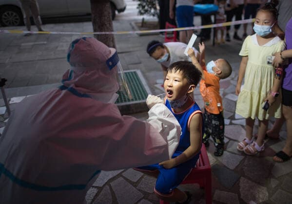 (210803) -- WUHAN, Aug. 3, 2021 -- A medical worker takes a swab sample from a child for COVID-19 nucleic acid testing in Wuhan, central China s Hubei Province, Aug. 3, 2021. Wuhan City, capital of central China s Hubei Province, launched another citywide COVID-19 nucleic acid testing campaign on Tuesday, according to a press conference held by the provincial COVID-19 prevention and control headquarters. Wuhan, once hard-hit by COVID-19, identified new local clusters of cases on Monday when seven migrant workers at the Wuhan Economic & Technological Development Zone tested positive for the coronavirus. ) CHINA-HUBEI-WUHAN-COVID-19-TESTING (CN) XiaoxYijiu