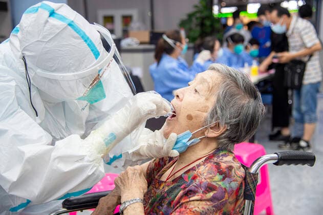 (210803) -- WUHAN, Aug. 3, 2021 -- A medical worker takes a swab sample from a resident for COVID-19 nucleic acid testing in Wuhan, central China s Hubei Province, Aug. 3, 2021. Wuhan City, capital of central China s Hubei Province, launched another citywide COVID-19 nucleic acid testing campaign on Tuesday, according to a press conference held by the provincial COVID-19 prevention and control headquarters. Wuhan, once hard-hit by COVID-19, identified new local clusters of cases on Monday when seven migrant workers at the Wuhan Economic & Technological Development Zone tested positive for the coronavirus. (Photo by Xinhua) CHINA-HUBEI-WUHAN-COVID-19-TESTING (CN) WuxZhizun