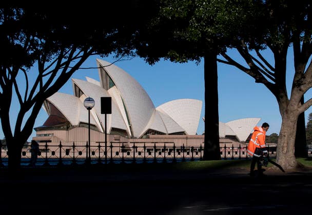 (210804) -- SYDNEY, Aug. 4, 2021 -- A staff member cleans a footpath near Sydney Opera House in Sydney, Australia, Aug. 4, 2021. As of Tuesday afternoon, there had been 34,833 confirmed cases of COVID-19 in Australia, and the number of locally acquired cases in the previous 24 hours was 219, according to the latest figures from the Department of Health. Recently, the country s most populous city of Sydney in the state of New South Wales (NSW), continued to battle the outbreak of COVID-19 triggered by the Delta variant. ) AUSTRALIA-SYDNEY-COVID-19-CASES BaixXuefei