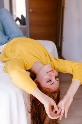 Young woman resting on bed in bedroom at home model released Symbolfoto property released TCEF01276