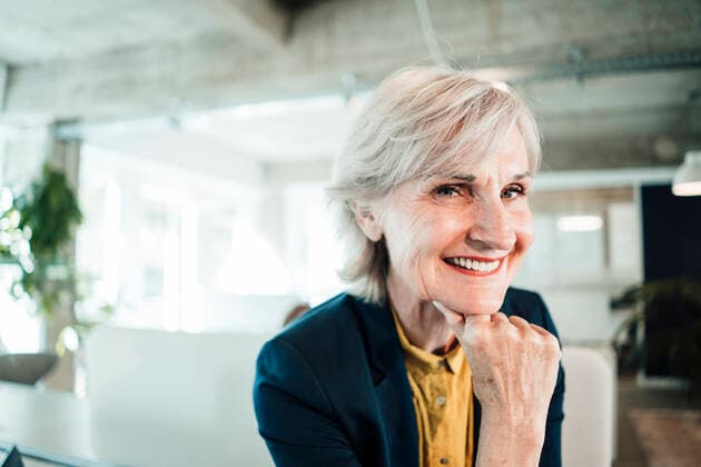 Smiling businesswoman with hand on chin at office model released property released, JOSEF06024