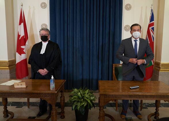 January 18, 2022, Winnipeg, MB, CANADA: Doyle Piwniuk, right, Minister of Transportation and Infrastructure is sworn in as he stands with Richard Chartier, Administrator of the Province at the Manitoba Legislative Building in Winnipeg, Manitoba, Tuesday January 18, 2022. Winnipeg CANADA - ZUMAc35_ 20220118_zaf_c35_052 Copyright: xDavidxLipnowskix
