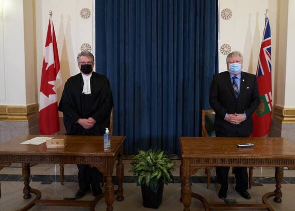 January 18, 2022, Winnipeg, MB, CANADA: Scott Johnston, right, Minister of Seniors and Long-Term Care is sworn in as he stands with Richard Chartier, Administrator of the Province at the Manitoba Legislative Building in Winnipeg, Manitoba, Tuesday January 18, 2022. Winnipeg CANADA - ZUMAc35_ 20220118_zaf_c35_054 Copyright: xDavidxLipnowskix