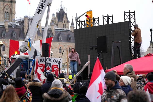 February 11, 2022, Ottawa, ON, CAN: A protester sings on a stage as another works on a giant TV screen behind, in front of Parliament Hill, on the 15th day of a protest against COVID-19 measures that has grown into a broader anti-government protest, in Ottawa, Friday, Feb. 11, 2022. Ottawa CAN - ZUMAc35_ 20220211_zaf_c35_176 Copyright: xJustinxTangx