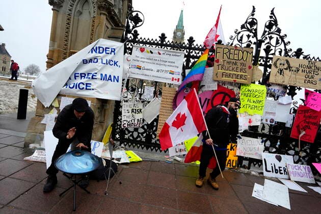 February 11, 2022, Ottawa, ON, CAN: Protesters drum, dance and smoke in front of the QueenöÄÃ s Gates on Parliament Hill, on the 15th day of a protest against COVID-19 measures that has grown into a broader anti-government protest, in Ottawa, Friday, Feb. 11, 2022. Ottawa CAN - ZUMAc35_ 20220211_zaf_c35_178 Copyright: xJustinxTangx