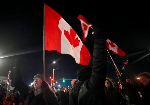 February 12, 2022, WINDSOR, ON, CANADA: A women cheers along with others as police have yet to enforce the midnight court injunction after blocking the access leading from the Ambassador Bridge, linking Detroit and Windsor, as truckers and their supporters continue to protest against the COVID-19 vaccine mandates and restrictions in Windsor, Ont., on Saturday, February 12, 2022. WINDSOR CANADA - ZUMAc35_ 20220212_zaf_c35_044 Copyright: xNathanxDenettex