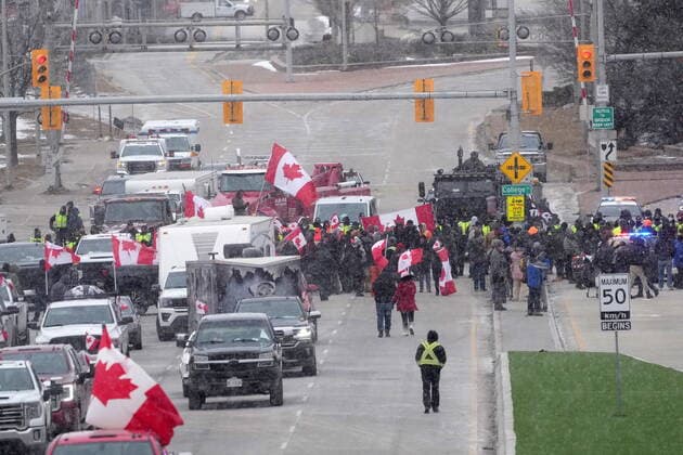 February 12, 2022, Windsor, ON, CANADA: Protesters face police officers as they enforce an injunction against their demonstration, which has blocked traffic across the Ambassador Bridge by protesters against COVID-19 restrictions, in Windsor, Ont., Saturday, Feb. 12, 2022. Windsor CANADA - ZUMAc35_ 20220212_zaf_c35_118 Copyright: xNathanxDenettex