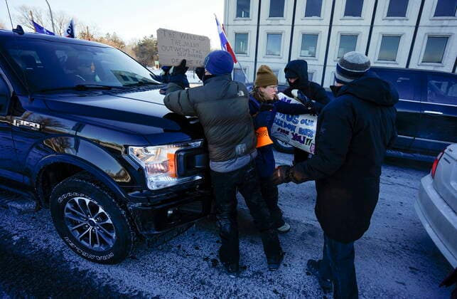 February 13, 2022, Ottawa, ON, CAN: A pickup truck driver uses his vehicle to slowly push against local residents, who were counter protesting vehicles from driving in a convoy en route to Parliament Hill, on the 17th day of a protest against COVID-19 measures that has grown into a broader anti-government protest, in Ottawa, Sunday, Feb. 13, 2022. Ottawa CAN - ZUMAc35_ 20220213_zaf_c35_057 Copyright: xJustinxTangx
