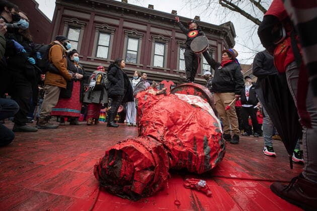 February 14, 2022, VANCOUVER, BC, CANADA: A person stands on top of the Gassy Jack statue after it was toppled and covered in red paint during the annual Women s Memorial March, in Vancouver, on Monday, February 14, 2022. The statue is a monument to Gassy Jack Deighton, a Vancouver saloon owner in the 1860s, whom Vancouver s Gastown neighbourhood is named after. The march is held to honour missing and murdered women and girls from the community with stops along the way to commemorate where women were last seen or found. VANCOUVER CANADA - ZUMAc35_ 20220214_zaf_c35_168 Copyright: xDarrylxDyckx