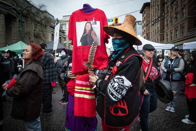 February 14, 2022, VANCOUVER, BC, CANADA: Rodney McMillan holds a t-shirt with a photo of his late sister Denise McMillan, who died of an overdose last year, as he listens to speeches before the annual Women s Memorial March, in Vancouver, on Monday, February 14, 2022. The march is held to honour missing and murdered women and girls from the community with stops along the way to commemorate where women were last seen or found. VANCOUVER CANADA - ZUMAc35_ 20220214_zaf_c35_199 Copyright: xDarrylxDyckx