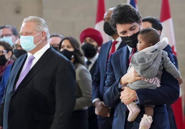 March 28, 2022, BRAMPTON, ON, CANADA: Prime Minister Justin Trudeau, centre, holds five-month-old Manal Hussen, right, as Ontario Premier Doug Ford looks on after reaching and agreement in $10-a-day child-care program deal in Brampton, Ont., on Monday, March 28, 2022. BRAMPTON CANADA - ZUMAc35_ 20220328_zaf_c35_021 Copyright: xNathanxDenettex