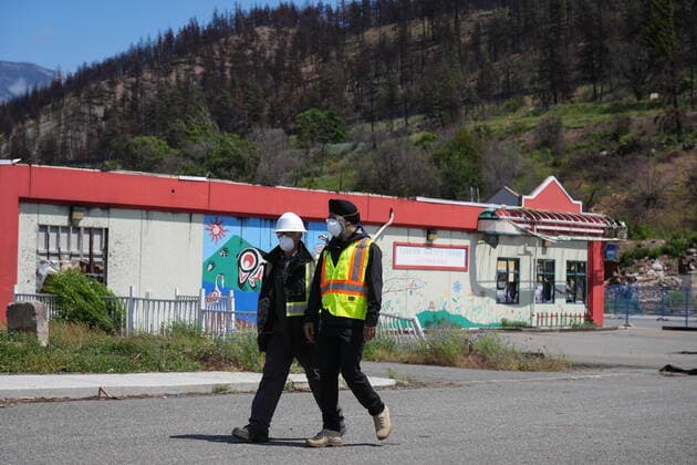 June 14, 2022, LYTTON, BC, CANADA: Harjit Sajjan, right, minister of International Development, views wildfire damage with Owen Collings, a resident who works as site support for the village, in Lytton, B.C., on Tuesday, June 14, 2022. The fire-ravaged community of Lytton, B.C., will get $77 million from the federal government to help it rebuild a fire-resistant and energy-efficient community. Two people were killed and much of the centre of the village was destroyed when wildfire ripped through the community almost a year ago. LYTTON CANADA - ZUMAc35_ 20220614_zaf_c35_073 Copyright: xDarrylxDyckx