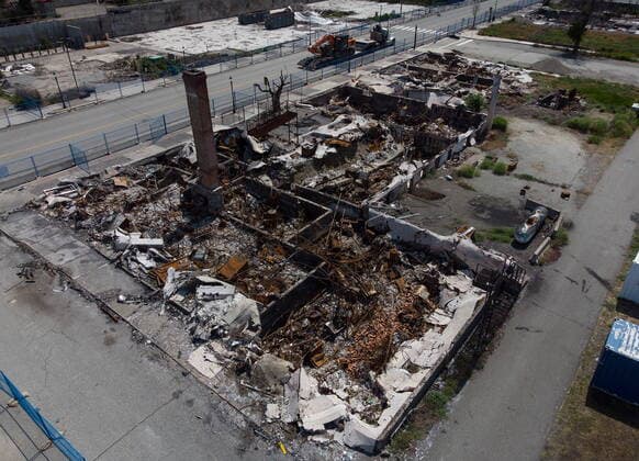 June 14, 2022, LYTTON, BC, CANADA: Heavy equipment used to clear debris is transported on Main Street past a hotel that was destroyed by wildfire in Lytton, B.C., on Tuesday, June 14, 2022. The fire-ravaged community of Lytton, B.C., will get $77 million from the federal government to help it rebuild a fire-resistant and energy-efficient community. Two people were killed and much of the centre of the village was destroyed when wildfire ripped through the community almost a year ago. LYTTON CANADA - ZUMAc35_ 20220614_zaf_c35_085 Copyright: xDarrylxDyckx