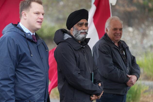 June 14, 2022, LYTTON, BC, CANADA: Harjit Sajjan, centre, minister of International Development, stands with Conservative MP Brad Vis, left, and Lytton Mayor Jan Polderman, right, after speaking during an announcement about funding to rebuild the village of Lytton, B.C., on Tuesday, June 14, 2022. The fire-ravaged community of Lytton, B.C., will get $77 million from the federal government to help it rebuild a fire-resistant and energy-efficient community. Two people were killed and much of the centre of the village was destroyed when wildfire ripped through the community almost a year ago. LYTTON CANADA - ZUMAc35_ 20220614_zaf_c35_099 Copyright: xDarrylxDyckx