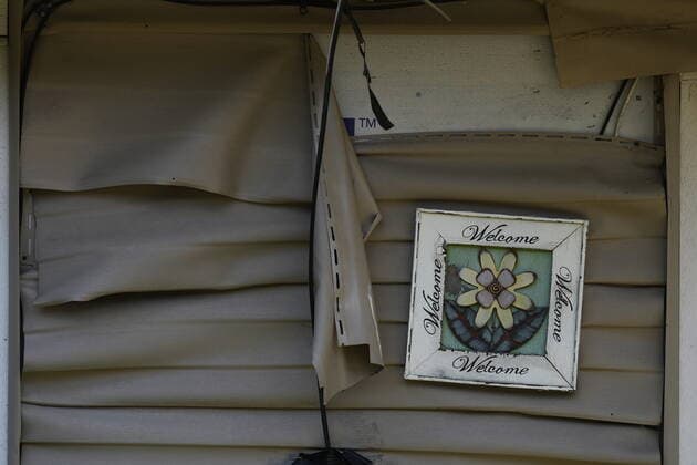 June 14, 2022, LYTTON, BC, CANADA: Melted vinyl siding and a welcome sign are seen on a house that remains standing after last year s devastating wildfire, in Lytton, B.C., on Tuesday, June 14, 2022. The fire-ravaged community of Lytton, B.C., will get $77 million from the federal government to help it rebuild a fire-resistant and energy-efficient community. Two people were killed and much of the centre of the village was destroyed when wildfire ripped through the community almost a year ago. LYTTON CANADA - ZUMAc35_ 20220614_zaf_c35_100 Copyright: xDarrylxDyckx