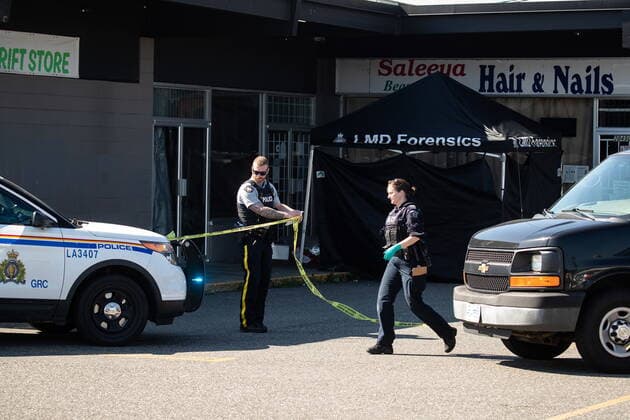 July 25, 2022, LANGLEY, BC, CANADA: An RCMP officer moves police tape near a tent covering a body at one of three locations being investigated in regards to multiple shootings, in Langley, B.C., on Monday, July 25, 2022. A suspect is in custody after several people were shot in the Metro Vancouver city of Langley, RCMP said. Police issued a blaring cellphone alert at about 6:20 Monday morning, saying they were at the scenes of several shootings involving transient victims. LANGLEY CANADA - ZUMAc35_ 20220725_zaf_c35_125 Copyright: xDarrylxDyckx