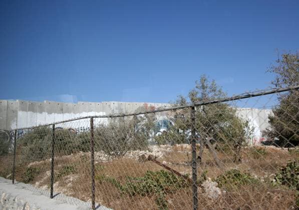 Israeli separation wall in the West Bank town of Bethlehem on October 05, 2006. , 21231614.jpg, apartheid, bank, barrier, graffiti, israeli, land, palestine, separation, sky, wall, west, bethlehem, board, fence, holy, israeli, occupation, palestinian, tower, wall, watchtower, west, barricade, blockade, blue, border, closure, guard, line, military, paint, restriction, security, settlement,