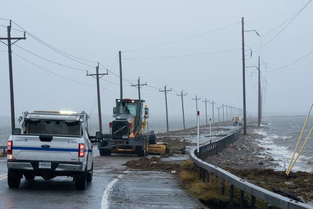 September 24, 2022, Žles-de-la-Madeleine, Que, CANADA: Highway crews clean debris caused by post-tropical storm Fiona on the Les ÃŽles-de-la-Madeleine, Que., Saturday, Sept. 24, 2022. Coastal flooding remains a threat for parts of Nova Scotia, Prince Edward Island including the Northumberland Strait, the Gulf of St. Lawrence region including Iles-de-la-Madeleine and eastern New Brunswick, southwest Newfoundland, the St. Lawrence Estuary and the Quebec Lower North Shore. Îles-de-la-Madeleine CANADA - ZUMAc35_ 20220924_zaf_c35_065 Copyright: xNigelxQuinnx