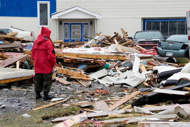 September 26, 2022, Port aux Basques, NL, CANADA: A Canadian Forces Ranger examines damage to a home in Port aux Basques, N.L., Monday, Sept. 26, 2022. Across the Maritimes, eastern Quebec and in southwestern Newfoundland, the economic impact of hurricane Fiona™s wrath is still being tallied. Port aux Basques CANADA - ZUMAc35_ 20220926_zaf_c35_129 Copyright: xFrankxGunnx