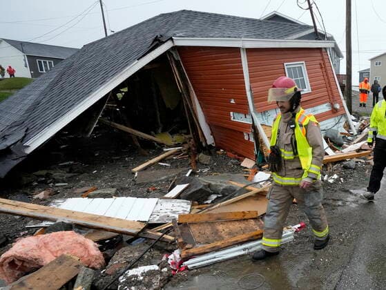 September 26, 2022, Port aux Basques, NL, CANADA: A firefighter examines damage to a home in Port aux Basques, N.L., Monday, Sept. 26, 2022. Across the Maritimes, eastern Quebec and in southwestern Newfoundland, the economic impact of hurricane Fiona™s wrath is still being tallied. Port aux Basques CANADA - ZUMAc35_ 20220926_zaf_c35_134 Copyright: xFrankxGunnx