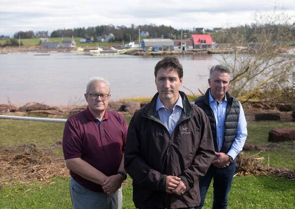 September 27, 2022, Stanley Bridge, PEI, Canada: Prime Minister Justin Trudeau speaks to reporters as he visits Stanley Bridge, P.E.I., to see the damage done by post-tropical storm Fiona, on Tuesday, Sept. 27, 2022. At left is Veterans Affairs Minister Lawrence MacAulay, at right, Liberal MP for Malpeque Heath MacDonald. Stanley Bridge Canada - ZUMAc35_ 20220927_zaf_c35_084 Copyright: xBrianxMcinnisx