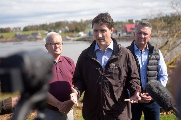 September 27, 2022, Stanley Bridge, PEI, Canada: Prime Minister Justin Trudeau speaks to reporters as he visits Stanley Bridge, P.E.I., to see the damage done by post-tropical storm Fiona, on Tuesday, Sept. 27, 2022. At left is Veterans Affairs Minister Lawrence MacAulay, at right, Liberal MP for Malpeque Heath MacDonald. Stanley Bridge Canada - ZUMAc35_ 20220927_zaf_c35_085 Copyright: xBrianxMcinnisx
