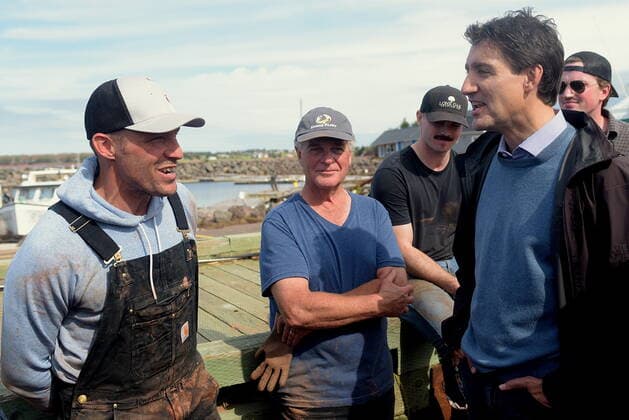 September 27, 2022, Stanley Bridge, PEI, Canada: Prime Minister Justin Trudeau speaks with Mitch Jollimore, left, lobster fisherman and business owner of StanleyöÄÃ s fish and chips and Basin View Seafood as he visits Stanley Bridge, P.E.I., to see the damage done by post-tropical storm Fiona, on Tuesday, Sept. 27, 2022. Stanley Bridge Canada - ZUMAc35_ 20220927_zaf_c35_087 Copyright: xBrianxMcinnisx