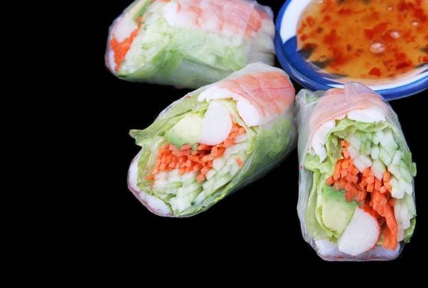 A salad roll with chili sauce on a black background with room for text Copyright: xLisaxF.xYoungx xDesignxPicsx , 30274970 Copyright: LisaxF.xYoungx xDesignxPics 30274970