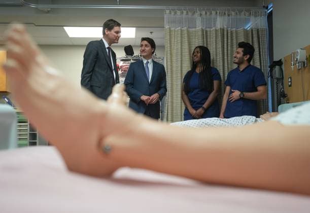 March 1, 2023, LANGLEY, BC, CANADA: B.C. Premier David Eby, left, and Prime Minister Justin Trudeau talk with psychiatric nursing students Derin Omojokun, third left, and Abdul Amarkhil, right, at Kwantlen Polytechnic University, in Langley, B.C., on Wednesday, March 1, 2023. The British Columbia government has agreed in principle to a $27.47-billion deal for health-care funding from the federal government. LANGLEY CANADA - ZUMAc35_ 20230301_zaf_c35_026 Copyright: xDarrylxDyckx
