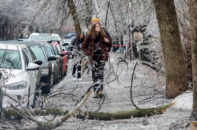 April 5, 2023, Montreal, PQ, Canada: People look up as fallen tree branches block a street following an accumulation of freezing rain in Montreal, Wednesday, April 5, 2023. Montreal Canada - ZUMAc35_ 20230405_zaf_c35_135 Copyright: xGrahamxHughesx