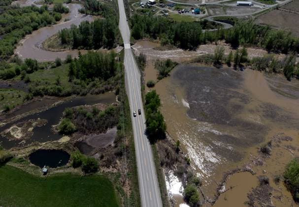 May 14, 2023, CACHE CREEK, BC, CANADA: Overland flooding is seen as the swollen Bonaparte River runs through the Bonaparte First Nation while motorists travel on the Cariboo Highway, north of Cache Creek, B.C., on Sunday, May 14, 2023. Environment Canada says unseasonably hot temperatures in British Columbia will persist over the coming days, with special weather statements warning of high river streamflows due to melting snow in hard-hit communities in the province s interior. CACHE CREEK CANADA - ZUMAc35_ 20230514_zaf_c35_113 Copyright: xDarrylxDyckx