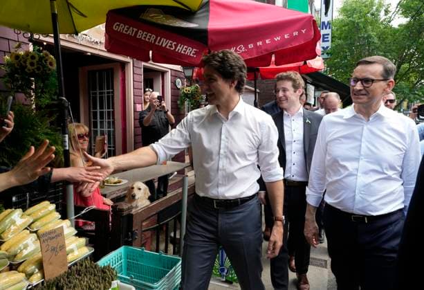 June 2, 2023, TORONTO, ON, Canada: Poland Prime Minister Mateusz Morawiecki, right, looks on as Prime Minister Justin Trudeau, centre, shakes hands with members of the public as they enjoy a walk in Toronto on Friday, June 2, 2023. TORONTO Canada - ZUMAc35_ 20230602_zaf_c35_068 Copyright: xFrankxGunnx
