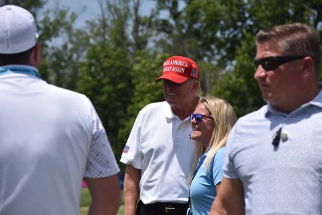 May 27, 2023, Sterling, Virginia, United States: Former President of the United States Donald J. Trump takes photos, signs objects as he visits the driving range. Former President of the United States Donald J. Trump visits the driving range, meets fans and watches LIV Golf Washington DC 2023 Round 2 at Trump National Golf Club Washington DC in Sterling, Virginia, United States. Sterling United States - ZUMAs197 20230527_zaa_s197_141 Copyright: xKylexMazzax