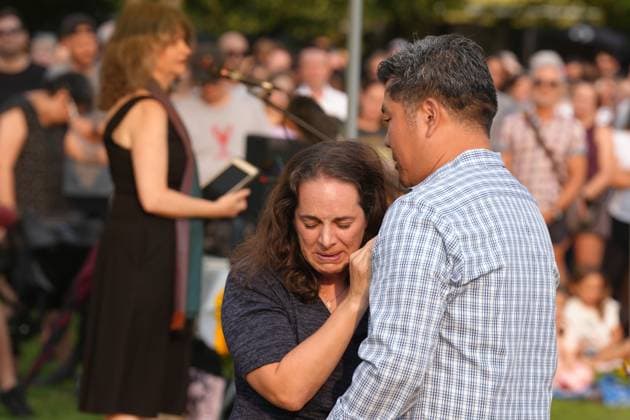July 17, 2023, TORONTO, ON, CAN: Marie Aragona, a friend of Karolina Huebner-Makurat, is comforted after speaking at a public vigil, in Toronto, Monday, July 17, 2023. Huebner-Makurat, a mother of two was killed by a stray bullet on July 7 after a shooting in her Leslieville neighbourhood. TORONTO CAN - ZUMAc35_ 20230717_zaf_c35_093 Copyright: xChrisxYoungx