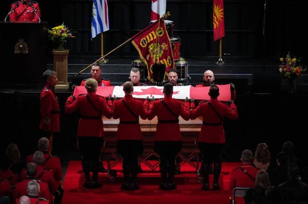 October 4, 2023, LANGLEY, BC, CANADA: Pallbearers fold the Canadian flag that draped RCMP Const. Rick O Brien s casket during a regimental funeral in Langley, B.C., on Wednesday, October 4, 2023. O Brien, 51, was killed last month while executing a search warrant at a home in Coquitlam. LANGLEY CANADA - ZUMAc35_ 20231004_zaf_c35_100 Copyright: xDarrylxDyckx