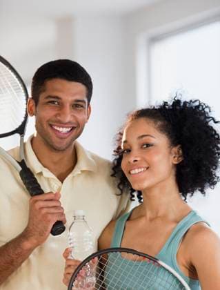 Couple holding tennis rackets Jersey City, NJ, 21.12.2023, model released, TTBB_BLD076684.jpg, 18-19 years, 25-29 years, african ethnicity, bottle, boyfriend, color image, confidence, exercise, fit, fitness, front view, girlfriend, happy, head and shoulders, healthy living, heterosexual couple, holding, husband, indoors, leisure activity, lifestyle, looking at camera, man, mixed race person, partner, people, photography, portrait, posing, racket, recreation, smiling, sports, standing, tennis, tennis player, together, togetherness, two people, vertical, water, weekend activities, wife, woman, young adult, young couple, minority, minorities2, 20s, 20-25, 20-30, 20s, 25-30, adult, african, african american, african-american, afro american, af Copyright: xJGI JamiexGrillx
