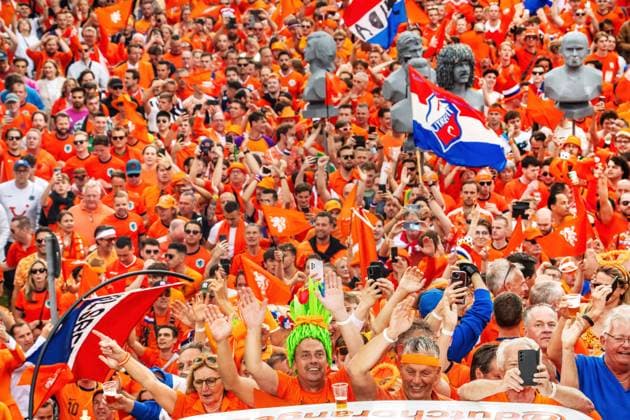 Tausende fröhliche Oranje Fans ziehen durch den Olympiapark zur Fan Zone, Fan-Walk, UEFA EURO 2024, München, 2. Juli 2024 Deutschland, München, 2. Juli 2024, Fan-Marsch der niederländischen Fußballfans zum Olympiapark, tausende fröhliche Oranje Fans treffen sich schon mittags und ziehen mit DJ und Musik zur Fan Zone, hier Szene am Spiridon-Louis-Ring, feiern dann gemeinsam mit rumänischen Anhängern eine riesige Party, vor dem Spiel Niederlande-Rumänien um 18 Uhr, UEFA EURO 2024, Fußball-Europameisterschaft, Fußball, Sport,