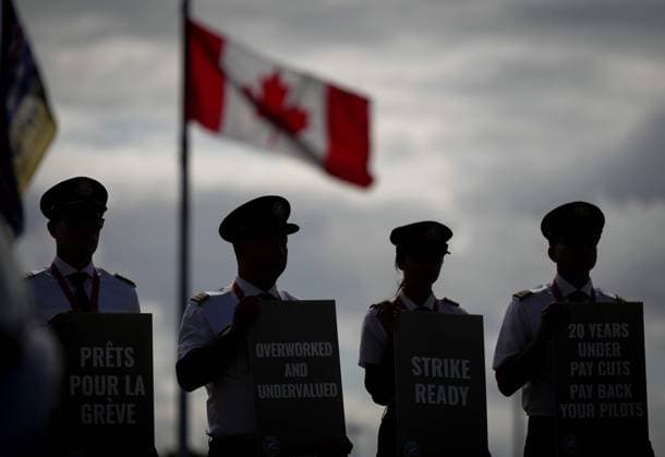 August 27, 2024, Richmond, Bc, CANADA: Air Canada pilots air silhouetted while holding signs during an informational picket at Vancouver International Airport in Richmond, B.C., on Tuesday, August 27, 2024. Air Canada pilots voted overwhelmingly to approve a strike mandate last week, putting them in a position to walk off the job as early as Sept. 17. The Air Line Pilots Association, which represents more than 5,400 aviators at the country s largest carrier, said the vote passed with 98 per cent support. Richmond CANADA - ZUMAc35_ 20240827_zaf_c35_035 Copyright: xDarrylxDyckx