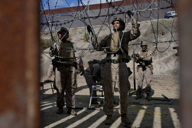 February 6, 2025, Tijuana, Baja California, Mexico: Members of the US Marine Corps install concertina wire along the US-Mexico border wall in San Diego, California, seen from Tijuana, Mexico in between the San Diego-Tijuana border fences of Colonia Libertad on Thursday, February 06, 2025. The Defense Department deployed 1,600 active-duty troops to the border during US President Donald Trumpâ€⠢s first week in office. Tijuana Mexico - ZUMAm180 20250206_zip_m180_003 Copyright: xCarlosxA.xMorenox