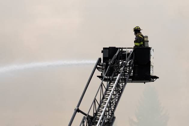 May 10, 2025, North Vancouver, Bc, CANADA: A North Vancouver Fire Department firefighter extinguishes a fire at Silverlynn Apartments, a three-storey seniors housing complex, in North Vancouver, B.C., Saturday, May 10, 2025. North Vancouver CANADA - ZUMAc35_ 20250510_zaf_c35_036 Copyright: xEthanxCairnsx